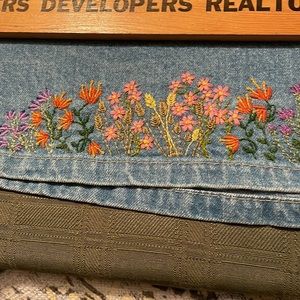 Denim skirt, buttons in the front, elastic back waist band and hand embroidery.